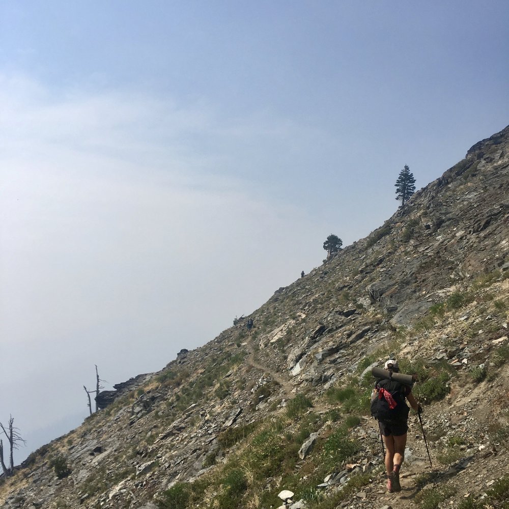 Indigo hiking a particularly steep ridge walk in Northern California. The intense smoke is coming from a wildfire in the valley below. We heard that they closed the trail the next day.